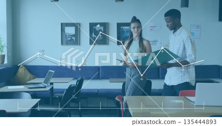 Collaborating coworkers reviewing documents and analytics overlay in office lounge, with laptop Collaborating coworkers reviewing documents and analytics overlay in office lounge, with laptop 135444893