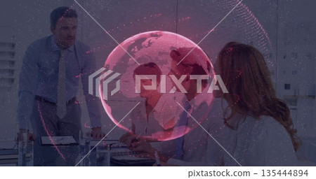 Displaying red translucent 3D globe overlay above conference room table, with laptop documents Displaying red translucent 3D globe overlay above conference room table, with laptop documents 135444894