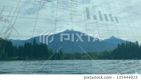 Blending snow-capped mountain peak reflecting on lake at conifer forest edge, with digital charts 135444923