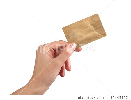 Bank card in hand finance close up. Eco kraft paper design with chip for purchase, payment and 135445122