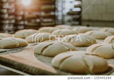 Dessert bread baking in oven. Production oven at the bakery. Baking bread. Dessert bread baking in oven. Production oven at the bakery. Baking bread. 135445284