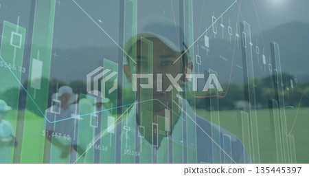 Standing golfer wearing light cap and polo shirt on fairway, showing financial data overlays 135445397