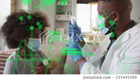 Doctor wearing lab coat drawing vaccine into syringe in home clinic with patient holding teddy bear Doctor wearing lab coat drawing vaccine into syringe in home clinic with patient holding teddy bear 135445399