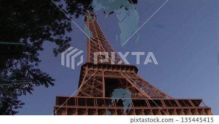 Rising Eiffel Tower reaching into Paris twilight sky, framing tree foliage and globe overlays Rising Eiffel Tower reaching into Paris twilight sky, framing tree foliage and globe overlays 135445415