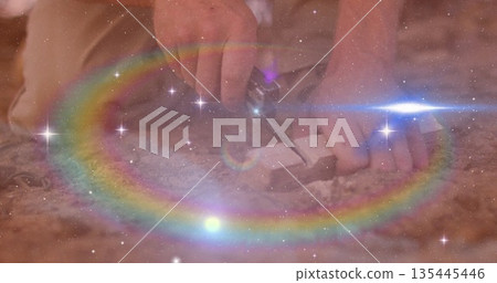 Craftsperson hands cutting wooden block on workshop floor, with small hand saw and sawdust Craftsperson hands cutting wooden block on workshop floor, with small hand saw and sawdust 135445446