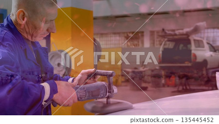Buffing mechanic in blue coverall polishing car hood in garage, with buffer and SUV, copy space 135445452