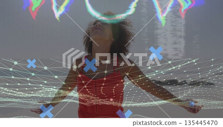 Standing woman in red sleeveless dress stretching arms on beach, with digital mesh glitch overlay Standing woman in red sleeveless dress stretching arms on beach, with digital mesh glitch overlay 135445470