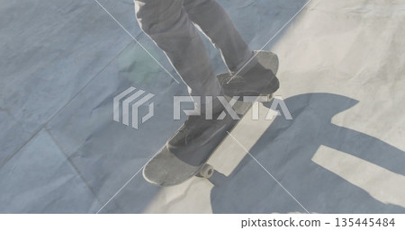 Balancing male wearing gray pants and black skate shoes on concrete ramp, with skateboard grip tape 135445484