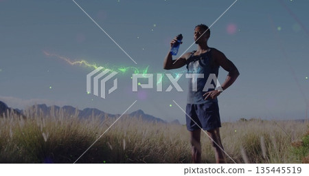 Drinking runner wearing sportswear and hydration pack at foothill, with watch and blue water bottle Drinking runner wearing sportswear and hydration pack at foothill, with watch and blue water bottle 135445519