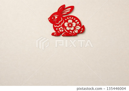 Red paper cut rabbit decoration on beige background with copy space, Chinese zodiac symbol and Lunar New Year concept 135446004