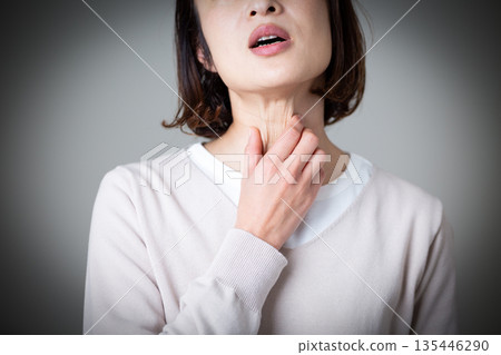 一位中年婦女痛苦地摀著喉嚨 135446290