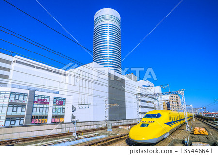 The golden age of Yokohama cityscape in Japan. View of Doctor Yellow and Yokohama Prince Hotel approaching Shin-Yokohama Station. The golden age of Yokohama cityscape in Japan. View of Doctor Yellow and Yokohama Prince Hotel approaching Shin-Yokohama Station. 135446641