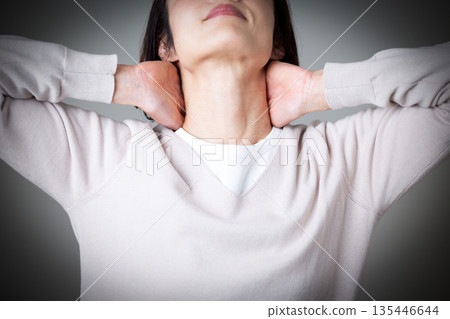 Middle-aged woman suffering from neck pain 135446644