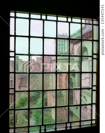 Medieval townscape seen through the window of the Gruuthuse Museum in Bruges, Belgium Medieval townscape seen through the window of the Gruuthuse Museum in Bruges, Belgium 135447241