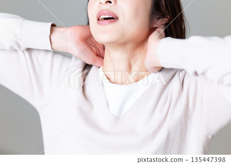 Middle-aged woman suffering from neck pain Middle-aged woman suffering from neck pain 135447398