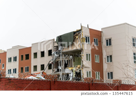 Building damaged in construction accident at urban site in early morning hours Building damaged in construction accident at urban site in early morning hours 135447615