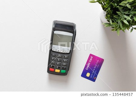 Black pos terminal and credit card top view 135448457