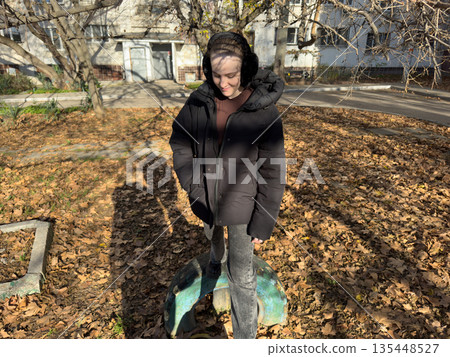Teenager standing fallen leaves old tire autumn cityscape Teenager standing fallen leaves old tire autumn cityscape 135448527