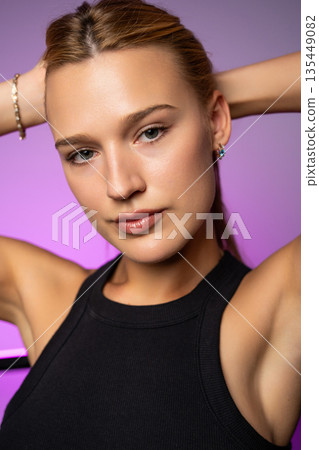 Close-up beauty portrait highlighting smooth, radiant skin, natural makeup, and a fresh healthy complexion in modern studio lighting. 135449082