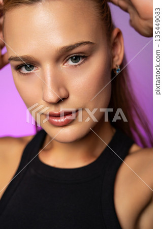 Close-up beauty portrait highlighting smooth, radiant skin, natural makeup, and a fresh healthy complexion in modern studio lighting. Close-up beauty portrait highlighting smooth, radiant skin, natural makeup, and a fresh healthy complexion in modern studio lighting. 135449083