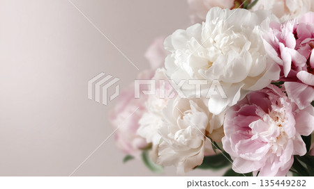 Peonies in soft colors arranged together on a light background during daytime Peonies in soft colors arranged together on a light background during daytime 135449282