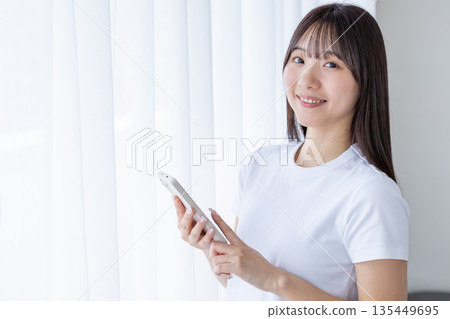 A young woman with a smartphone A young woman with a smartphone 135449695