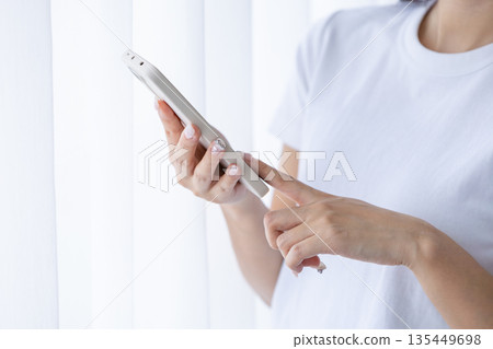 Young woman using a smartphone 135449698