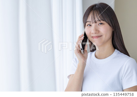 A young woman with a smartphone A young woman with a smartphone 135449758
