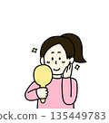 A smiling woman looking in the mirror 135449783