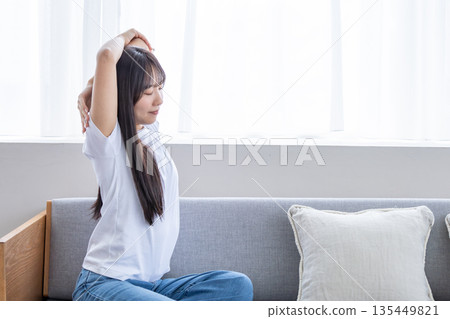 Young woman stretching on the sofa 135449821