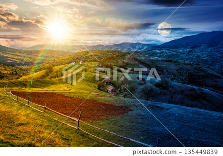 scenic view of arable and wooden fence on hills in rural area. day and night time change concept. beautiful countryside mountain landscape in spring with sun and moon. duality and transition template scenic view of arable and wooden fence on hills in rural area. day and night time change concept. beautiful countryside mountain landscape in spring with sun and moon. duality and transition template 135449839
