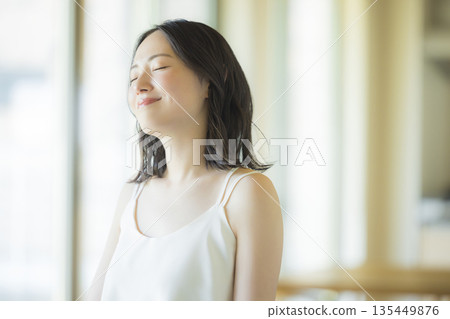 一位女士在客廳做頭髮護理 135449876