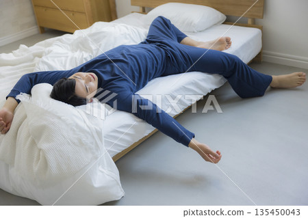 A man sleeping in bed A man sleeping in bed 135450043