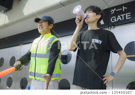 Staff guiding people at the event venue Staff guiding people at the event venue 135450167