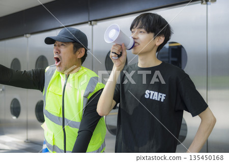 Staff guiding people at the event venue 135450168