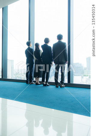 Rear view of a walking businessman Rear view of a walking businessman 135450314