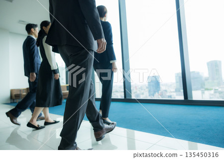 Rear view of a walking businessman 135450316