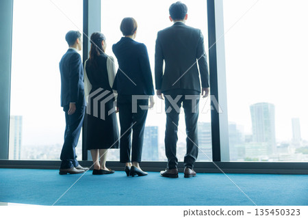 Rear view of a walking businessman 135450323