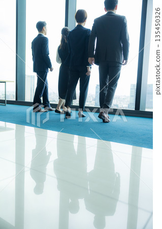 Rear view of a walking businessman Rear view of a walking businessman 135450326