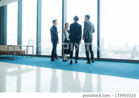 Rear view of a walking businessman 135450328