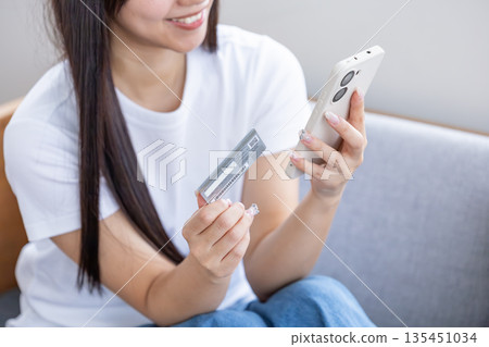 Young woman with smartphone and credit card Young woman with smartphone and credit card 135451034
