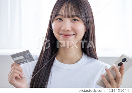 Young woman with smartphone and credit card Young woman with smartphone and credit card 135451044