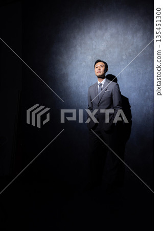 Businessman on a dark background 135451300