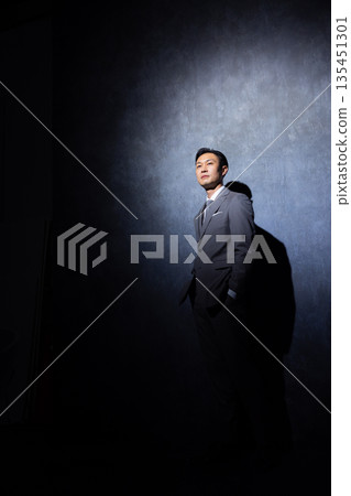 Businessman on a dark background Businessman on a dark background 135451301
