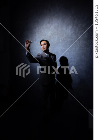 Businessman on a dark background 135451315