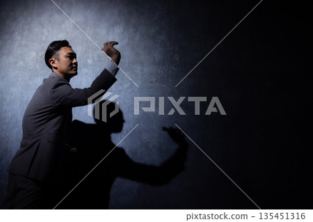 Businessman on a dark background Businessman on a dark background 135451316