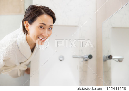 Woman in bathrobe Woman in bathrobe 135451358