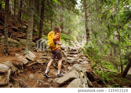 Young woman with backpack traveling outdoors. Hiking, active lifestyle. Young woman with backpack traveling outdoors. Hiking, active lifestyle. 135451528