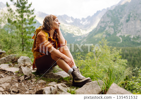 Close-up of female legs in hiking boots on a hiking trail. Travel, vacation. The concept of nature. Close-up of female legs in hiking boots on a hiking trail. Travel, vacation. The concept of nature. 135451532