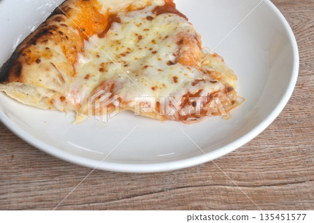 piece of baking homemade cheese pizza dressing tomato sauce on plate  135451577